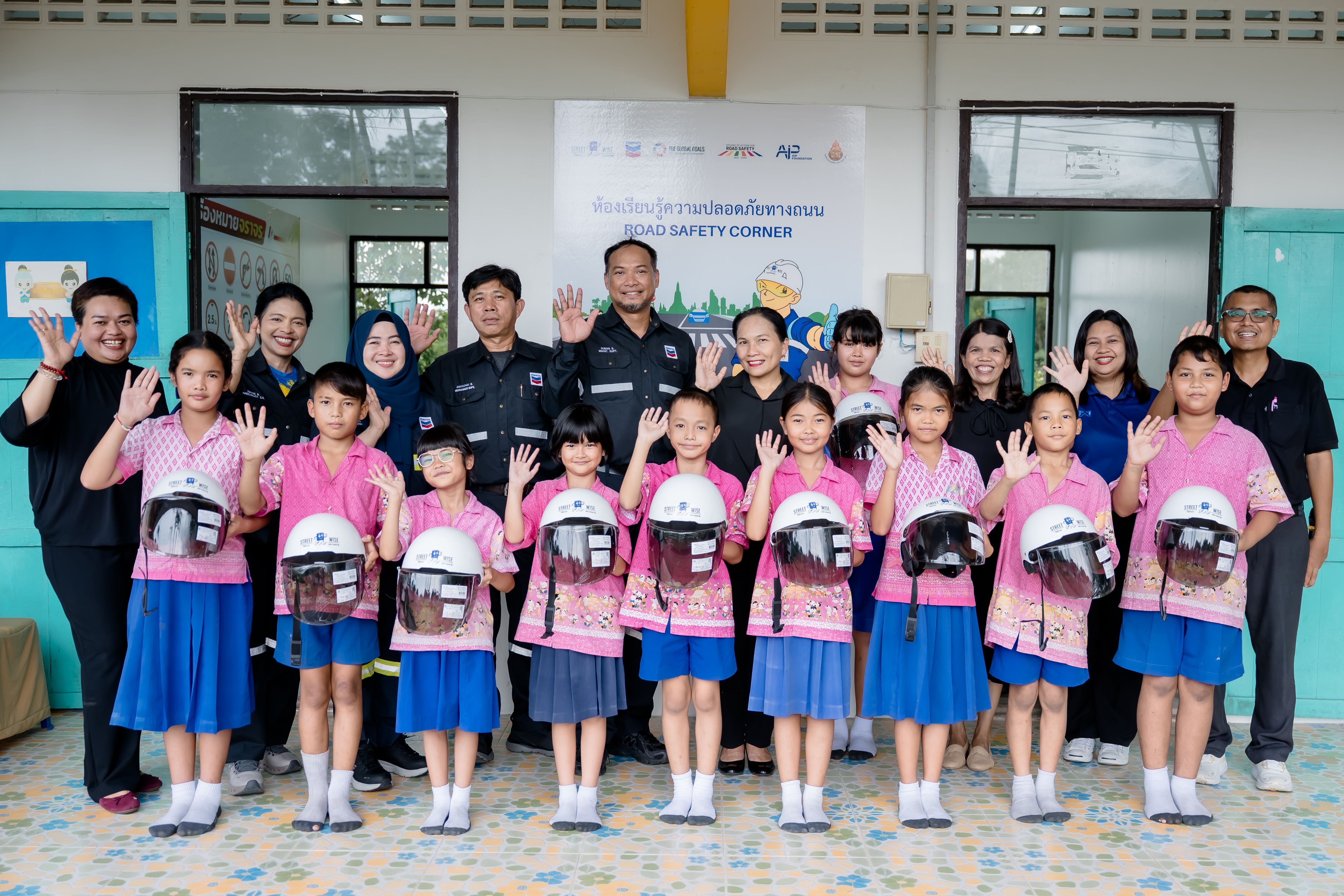 Students receive helmets and learn about road safety best practices.