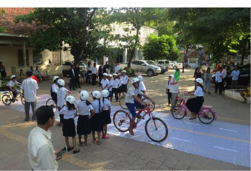 Students from Sothearos Primary School engage in an interactive game meant to reinforce their knowledge of road safety and helmet use.