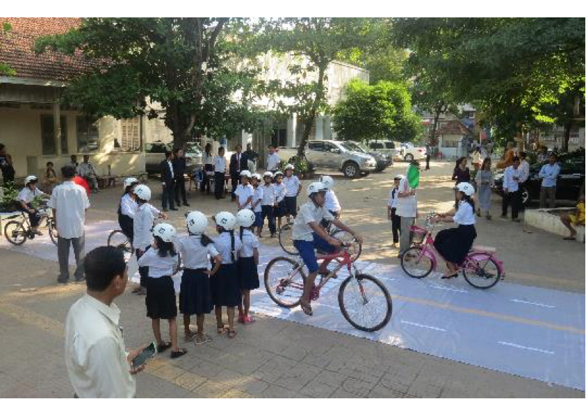 Students from Sothearos Primary School engage in an interactive game meant to reinforce their knowledge of road safety and helmet use.