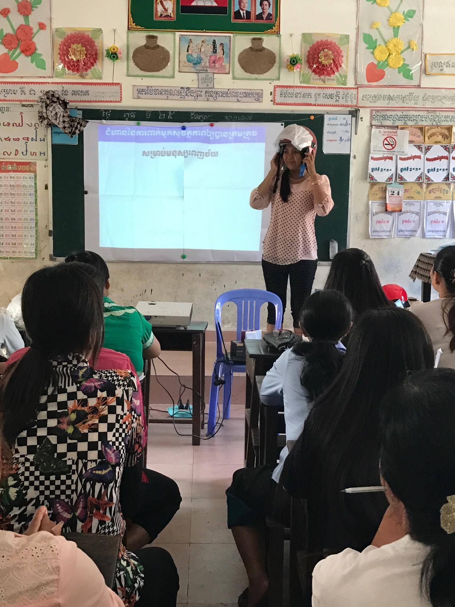 Teachers from Vealvong Primary School participate in a Helmets for Families road safety training.