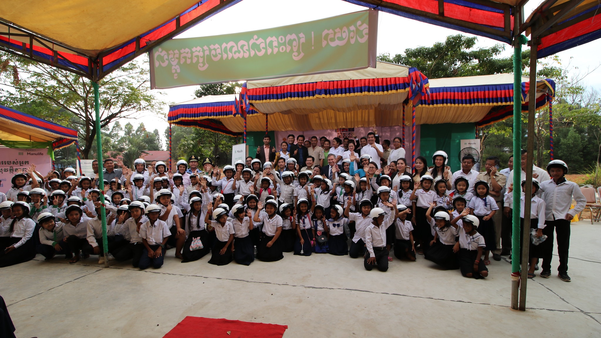 Manulife Cambodia CEO and General Manager, Robert J. Elliot joins stakeholders for ceremonial helmet handover
