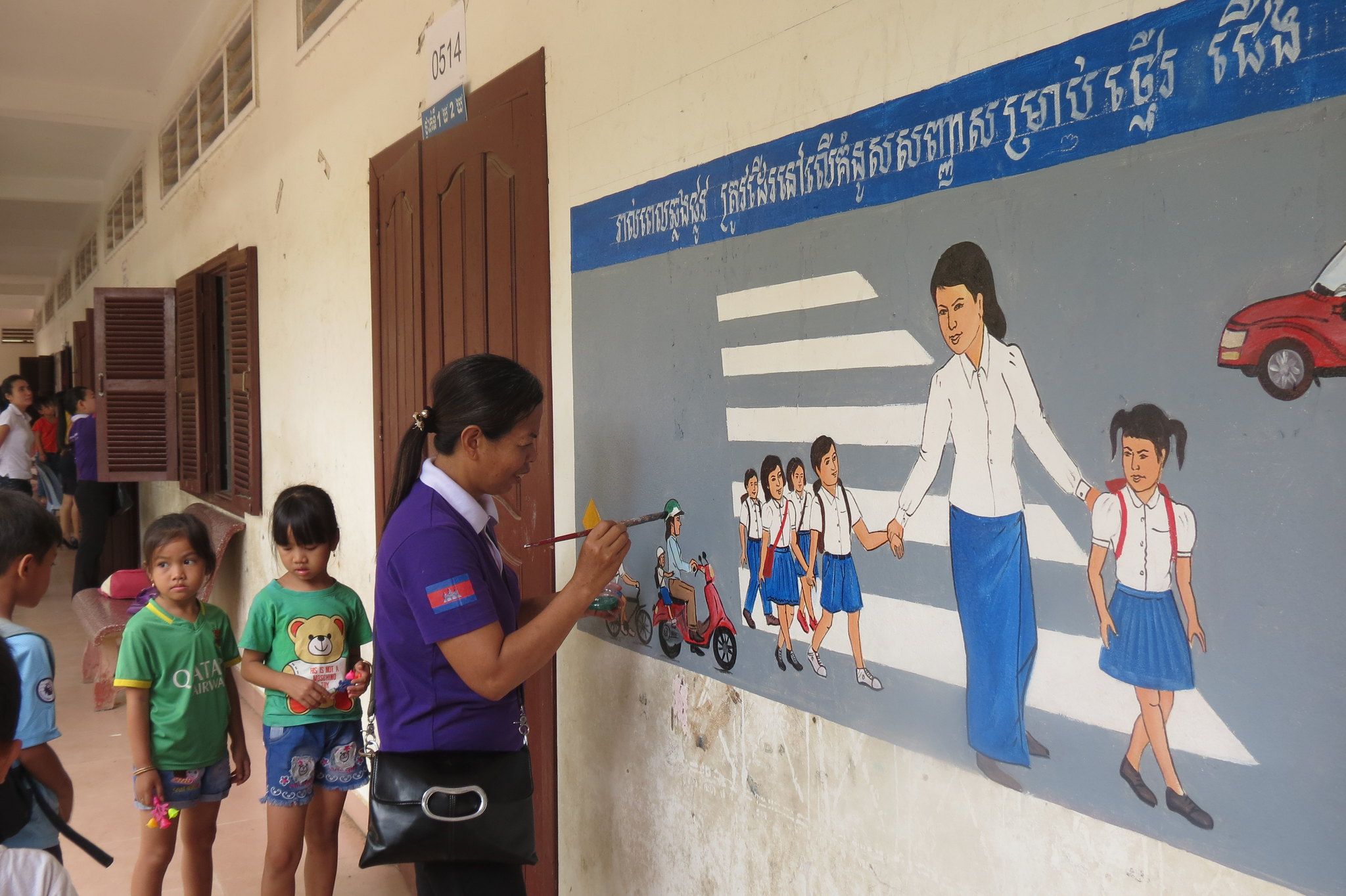 Manulife Cambodia and AIP Foundation staff paint road safety murals at Vealvong Primary School.