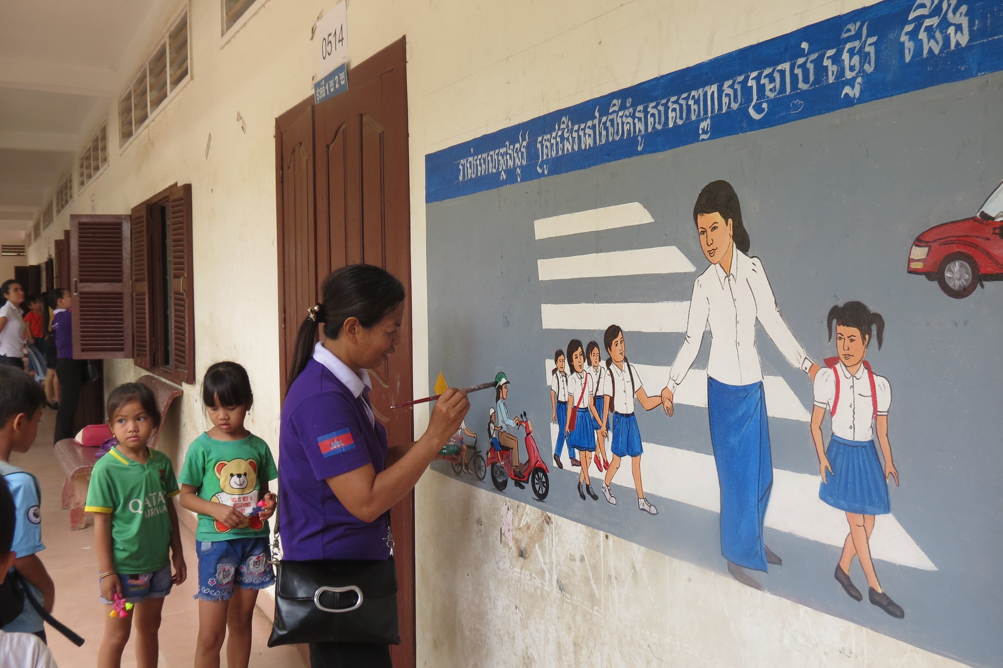 Manulife Cambodia and AIP Foundation staff paint road safety murals at Vealvong Primary School.