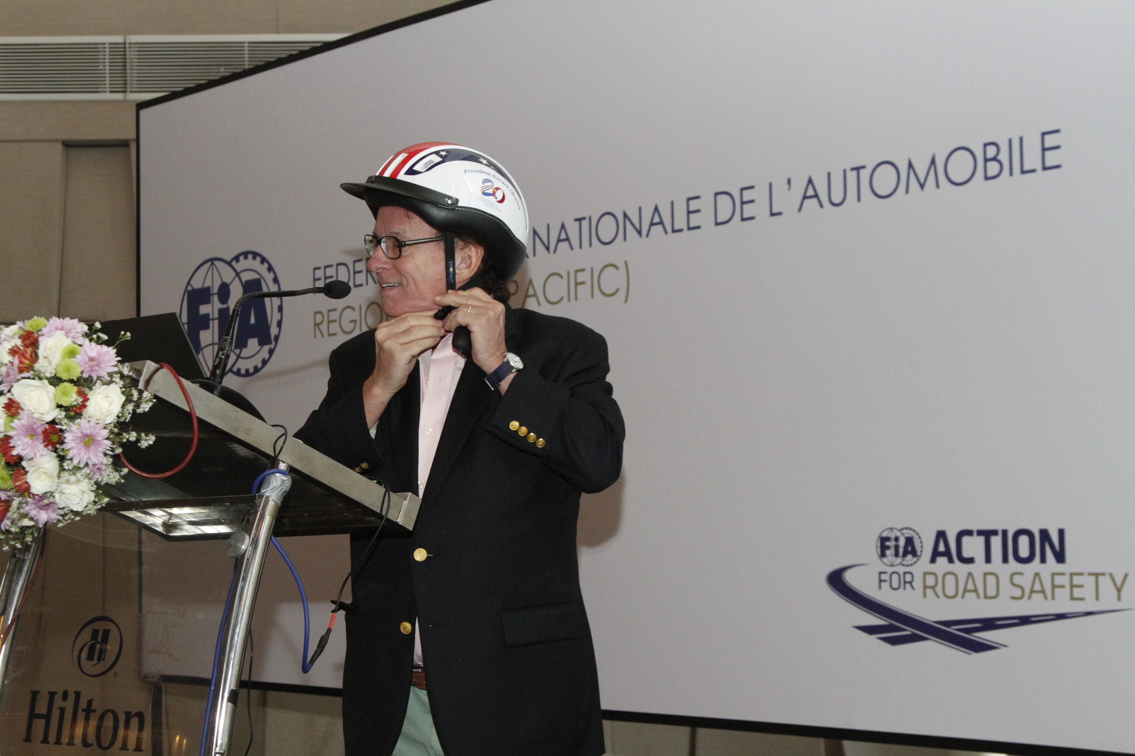 AIP Foundation President, Greig Craft, demonstrates how to properly wear a helmet during his presentation.