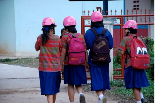 Students leave one of the project schools in Udon Thani wearing their helmets. This image would have been unthinkable just a few years ago, when there was no culture of helmet use in the area.