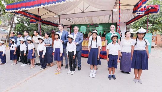 Manulife Cambodia representatives at a Helmets for Families helmet donation ceremony held in Kessararam Primary School in Siem Reap.