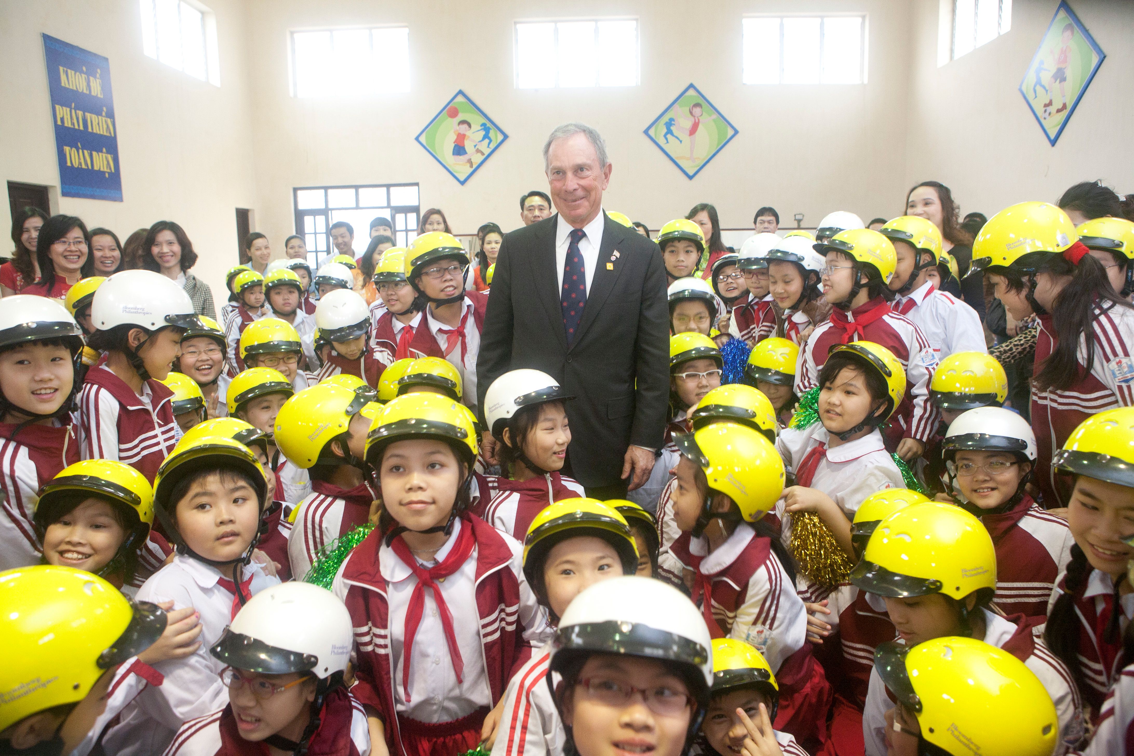 Michael R. Bloomberg shown here taking part in the kick-off event for a Helmets for Kids project in Hanoi in 2012.
