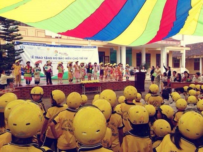 Students wear new helmets at the handover ceremony for the Children's Helmet Project, sponsored by Johnson & Johnson.