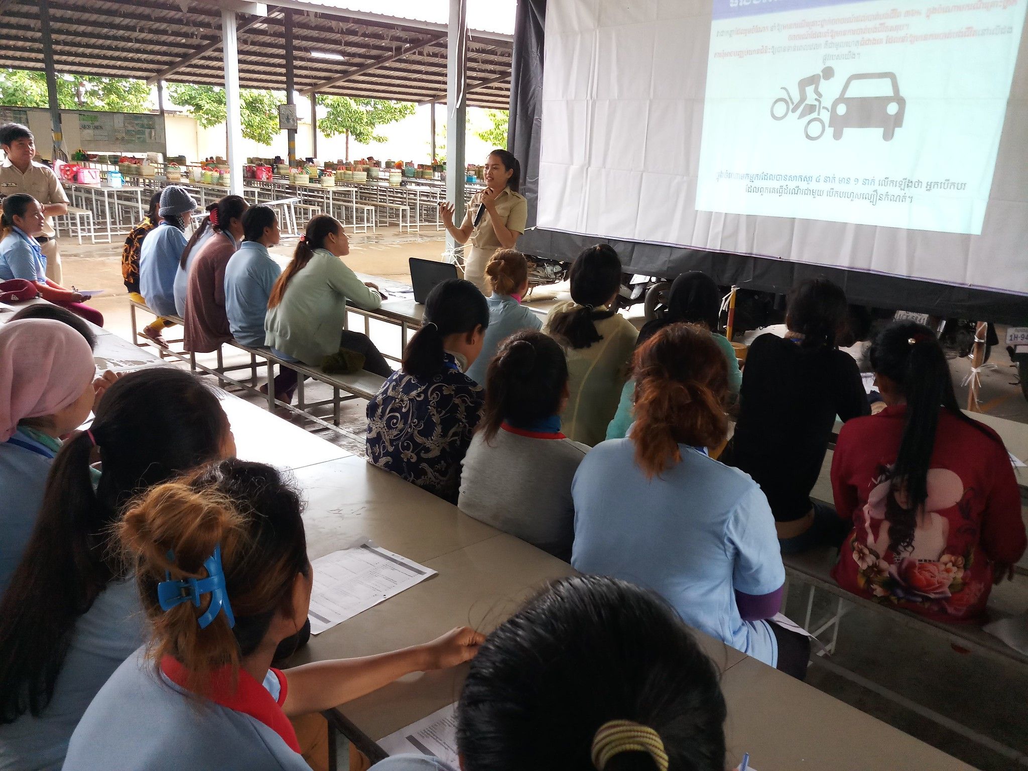 AIP Foundation staff demonstrate to trainers the correct way to wear a helmet at a garment factory