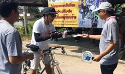 Volunteers stop a bicyclist to provide him with the information he needs to stay safe on the roads.