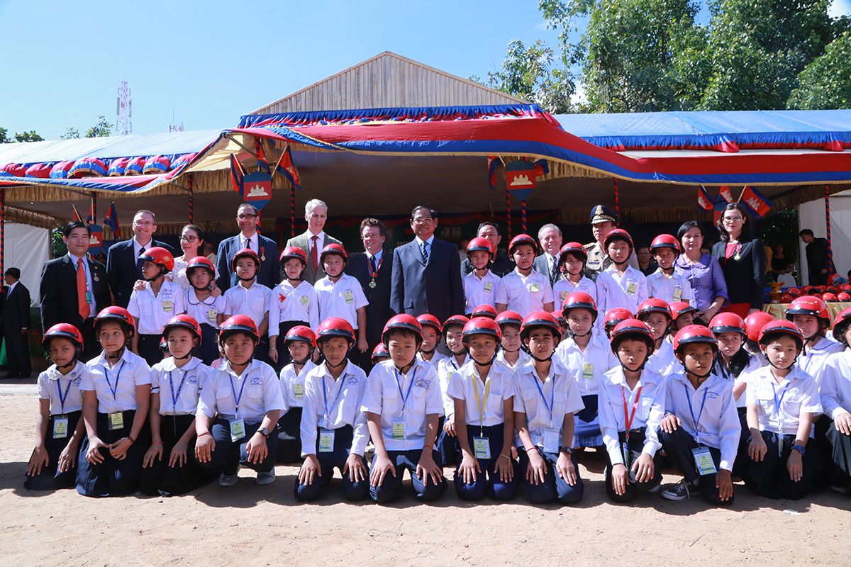 His Excellency Deputy Prime Minister Sar Kheng and special guests with student helmet recipients at “Head Safe. Helmet On.” helmet donation ceremony