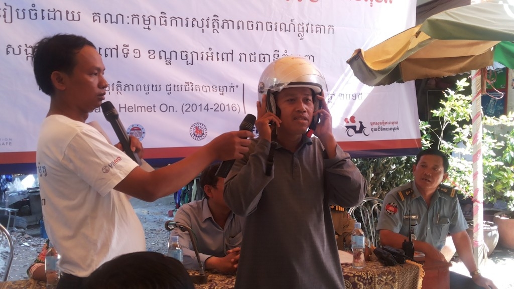 Participants at the meeting discuss helmet use