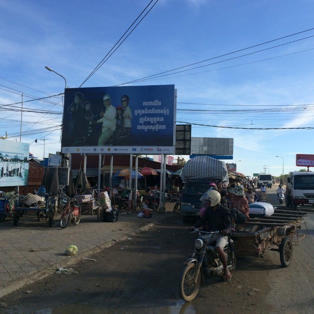 Billboard promotes helmet-wearing above busy streets