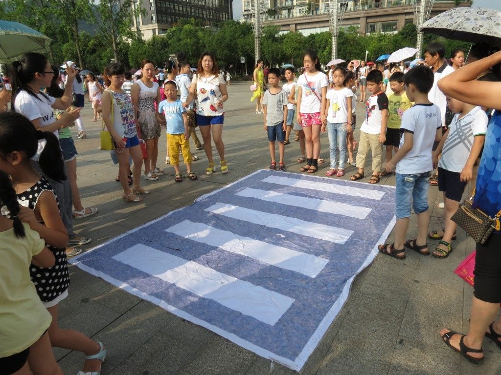 Children demonstrate their new skills on how to use a zebra crossing correctly