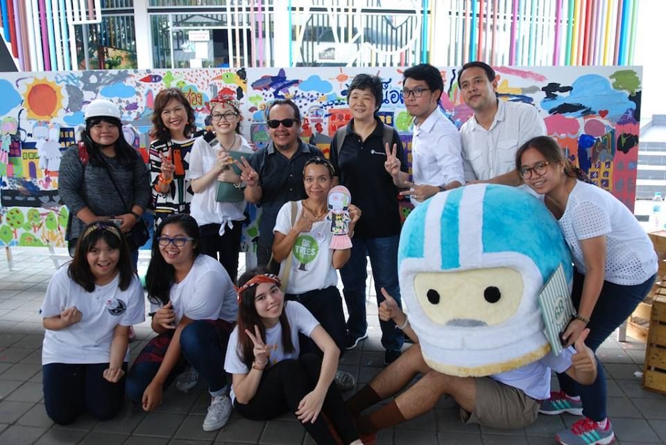Event participants display the road-safety-themed mural that was painted to raise awareness during the event.