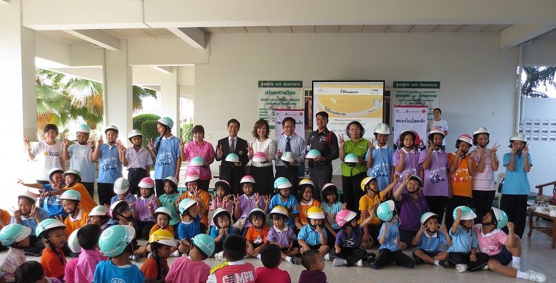 primary school students in Bangkok receive helmets as part of a helmet enforcement pilot