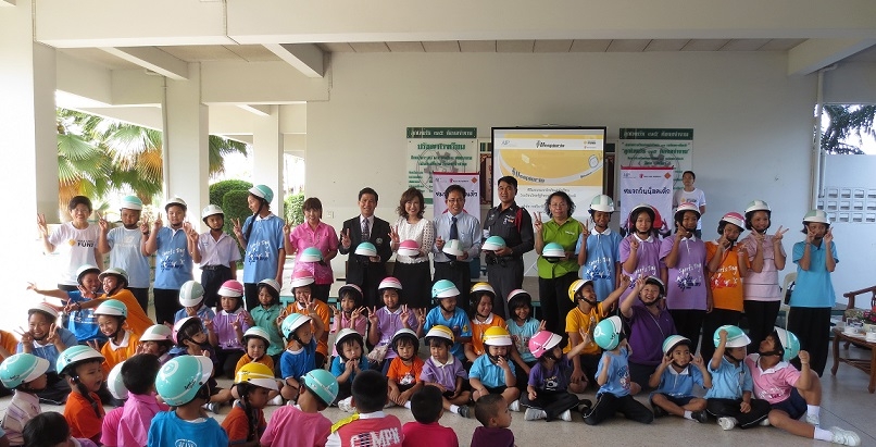 primary school students in Bangkok receive helmets as part of a helmet enforcement pilot