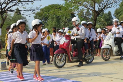 Manulife volunteers enforce safe pedestrian and motorcycle behaviors through a driving simulation