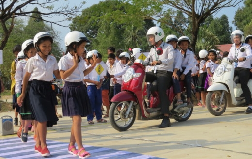 Manulife volunteers enforce safe pedestrian and motorcycle behaviors through a driving simulation