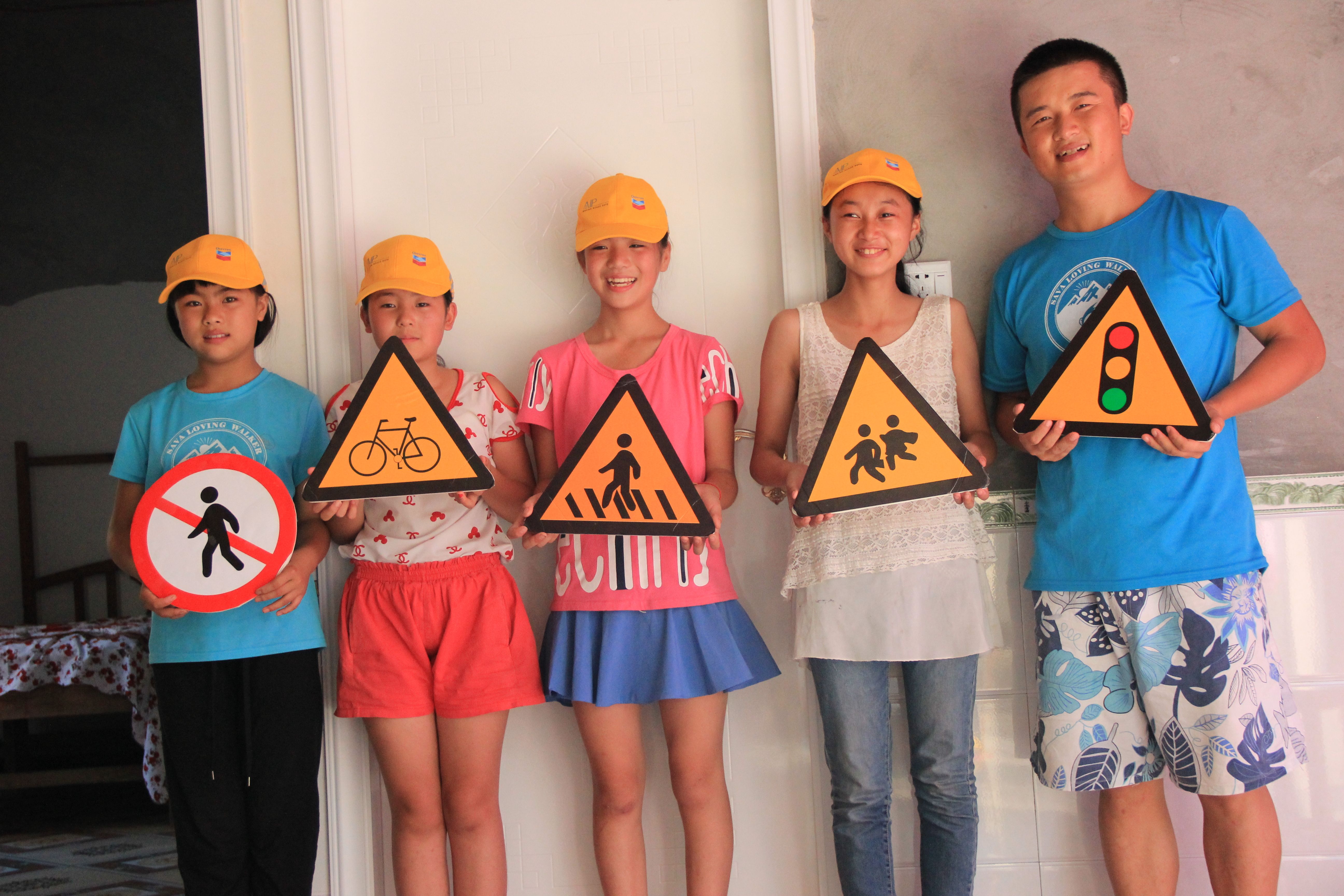 Children in Kai County display the pedestrian safety knowledge they gained during the recent Walk Wise volunteer initiative.