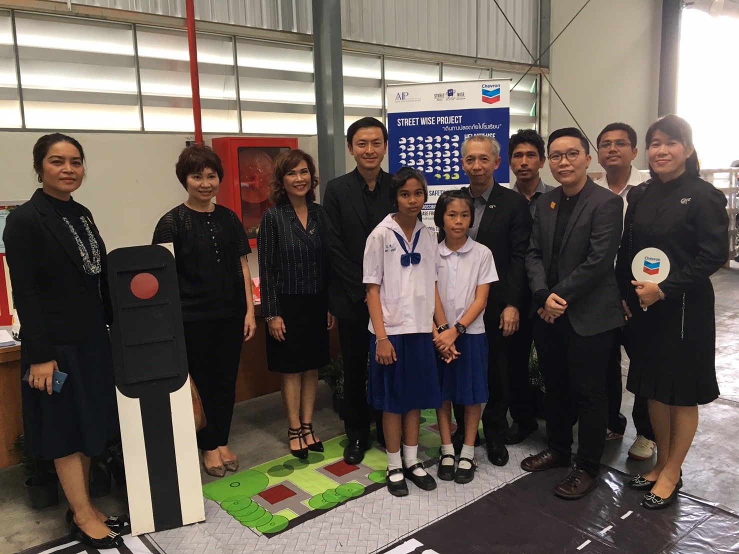 Representatives from the government, Chevron, AIP Foundation, and program schools join students during the Street Wise Phase 2 announcement ceremony.