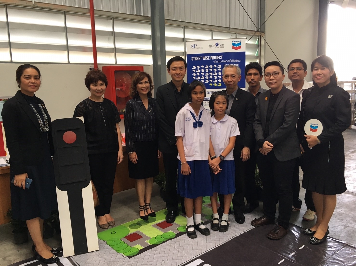 Representatives from the government, Chevron, AIP Foundation, and program schools join students during the Street Wise Phase 2 announcement ceremony.