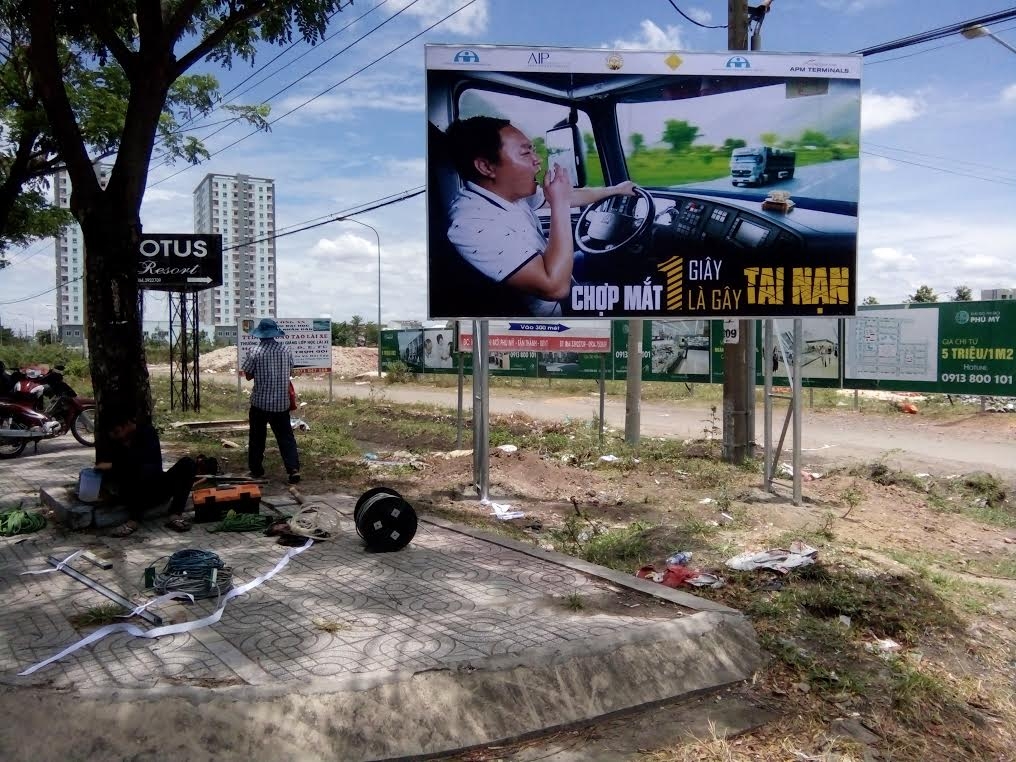 A billboard raises awareness about the dangers of drowsy driving among truck drivers.