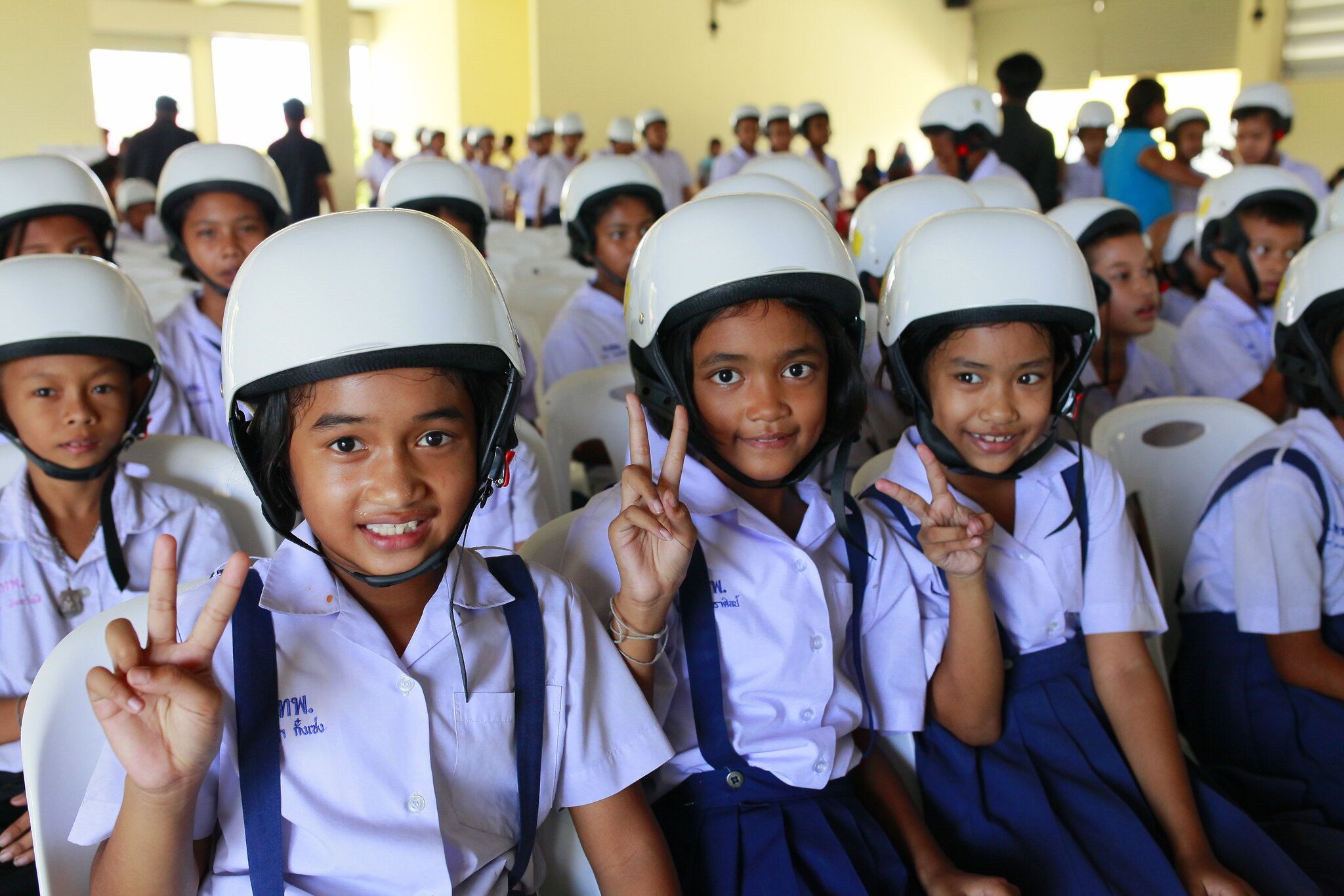 Students wearing their new helmets at the launch ceremony for Helmets for Kids.