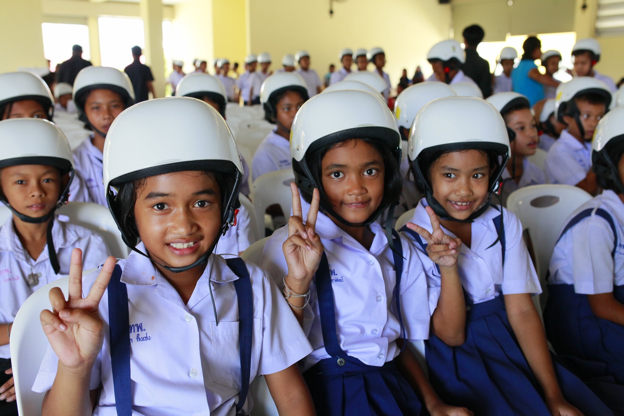 Students wearing their new helmets at the launch ceremony for Helmets for Kids.