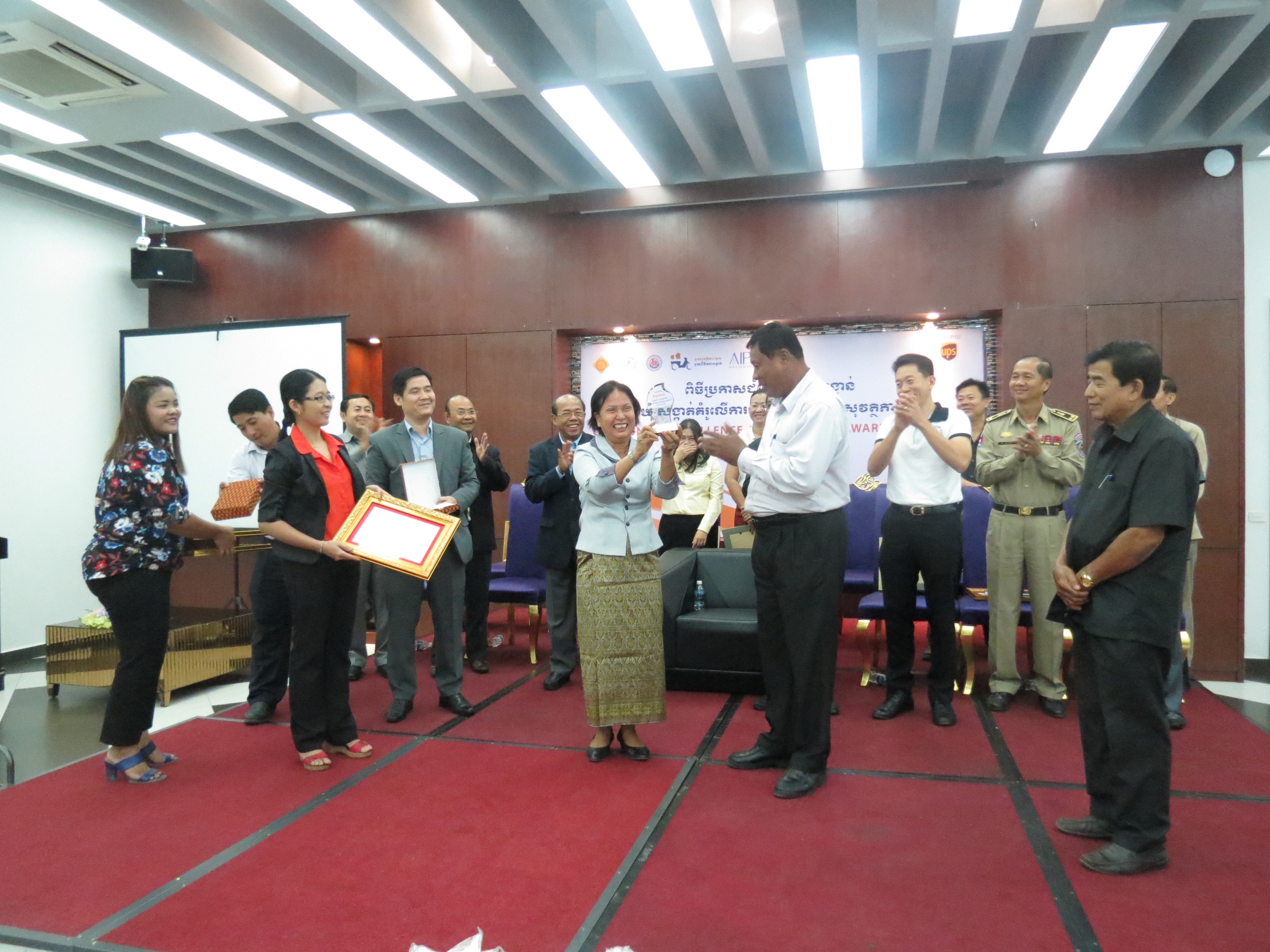 Recipients of the top prizes in the competition accept their certificates after succeeding in improving the cohesion and efficacy of road safety activities in their commune.