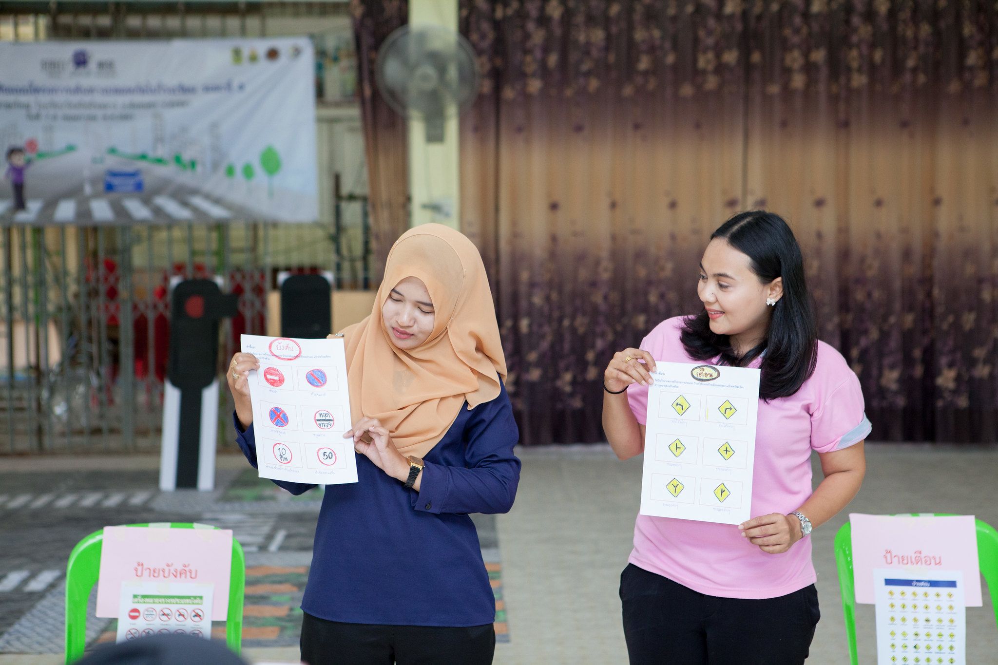 Teachers participate in training activities using traffic signs and games.