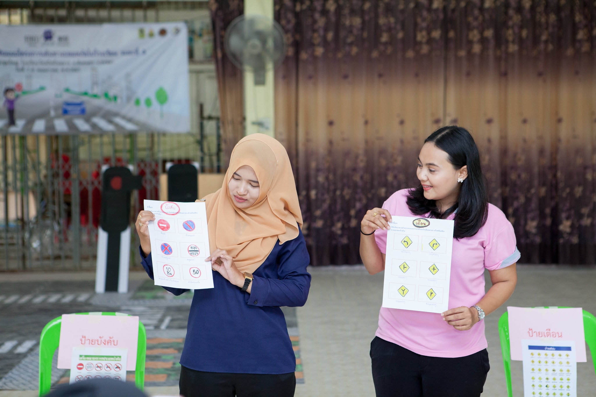 Teachers participate in training activities using traffic signs and games.