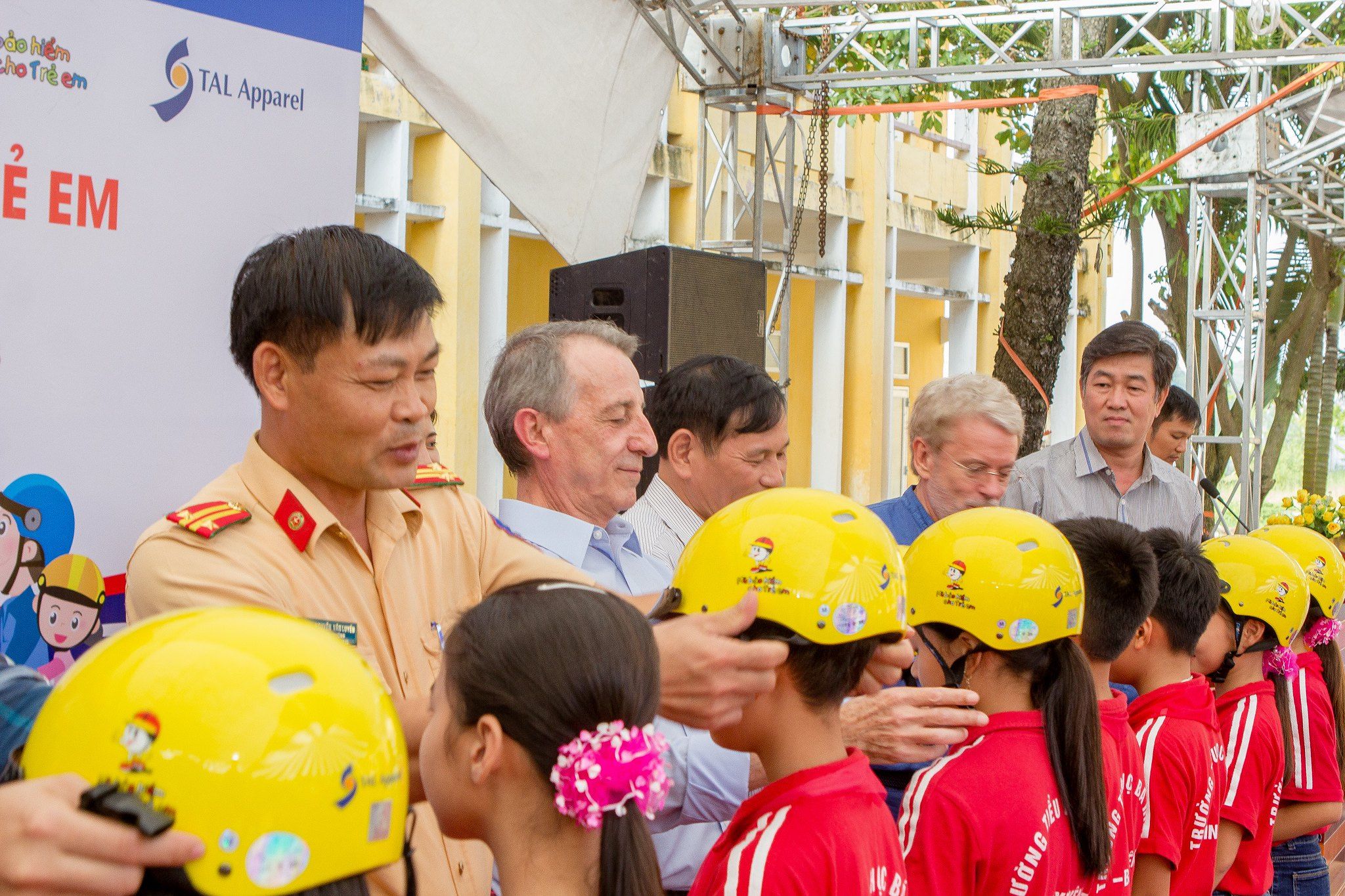 Mr. Tony Iacurto, Health and Safety Director of TAL Apparel and Stakeholders perform the ceremonial helmet handover