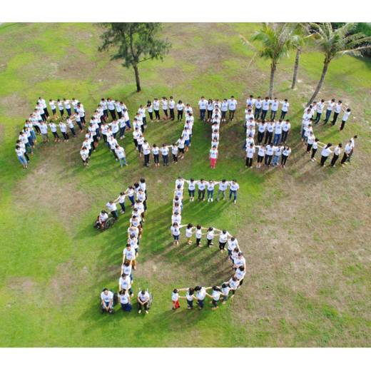 Protec staff work together to show their excitement over reaching this milestone.