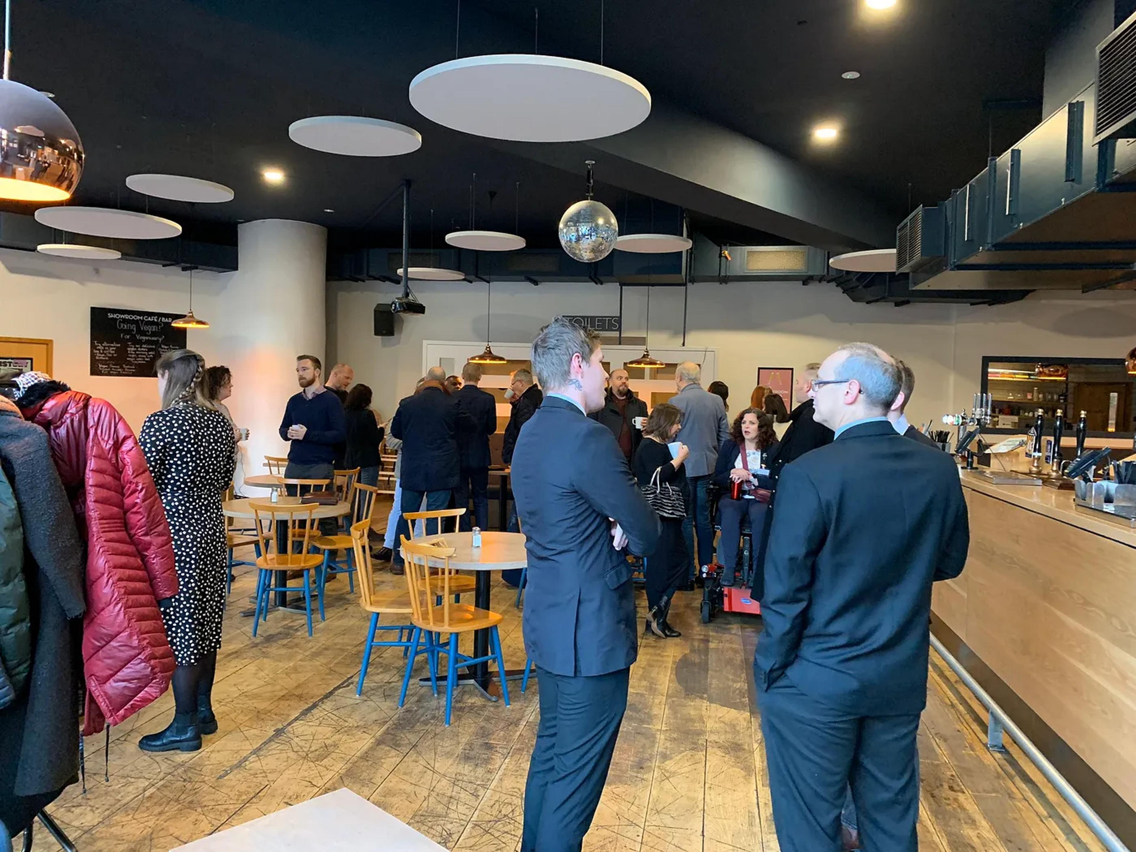 a group of people talking in a big room
