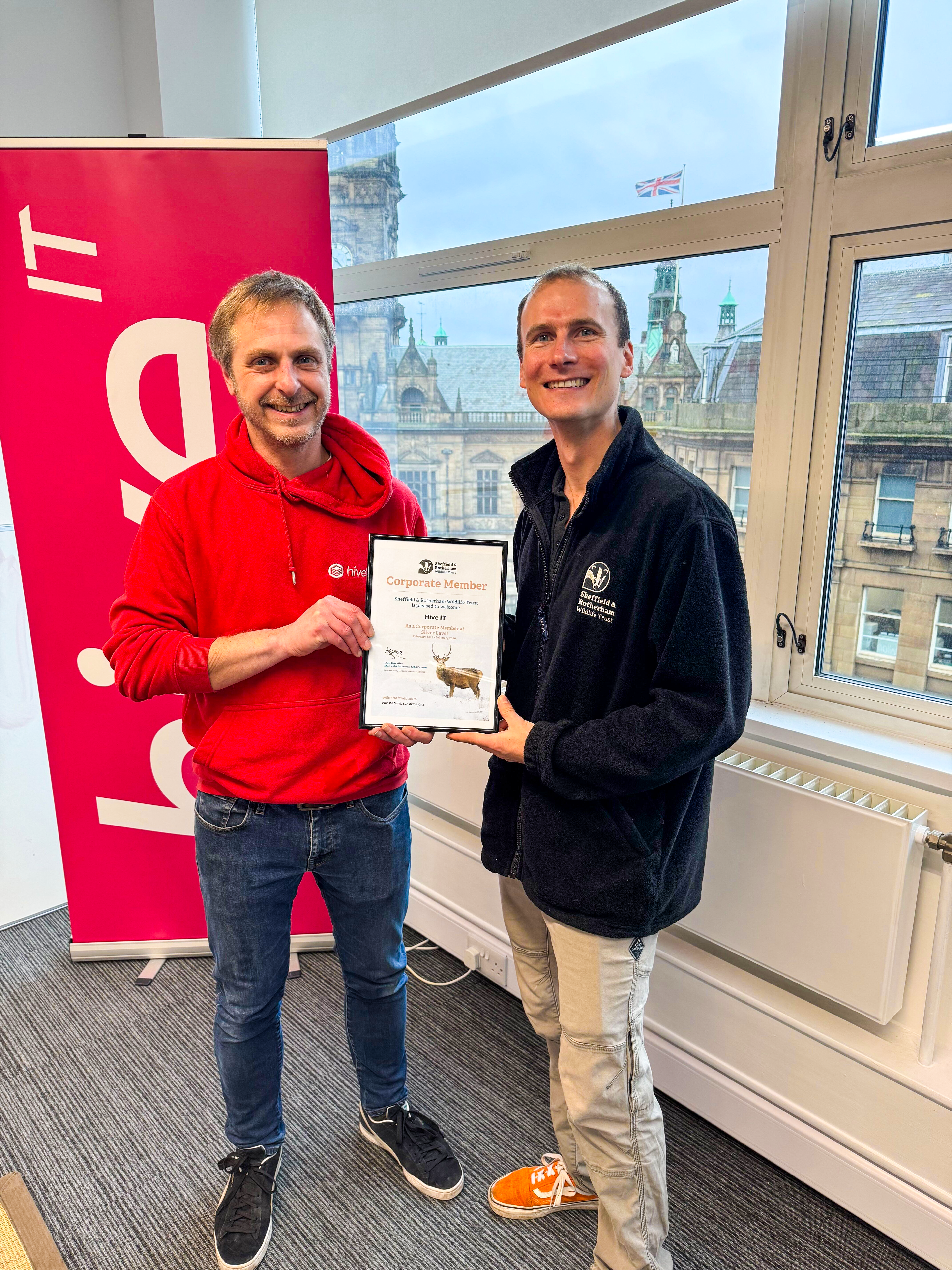 Jonny from Hive IT and Paul Hodges posing for a picture holding the SRWT corporate certificate 