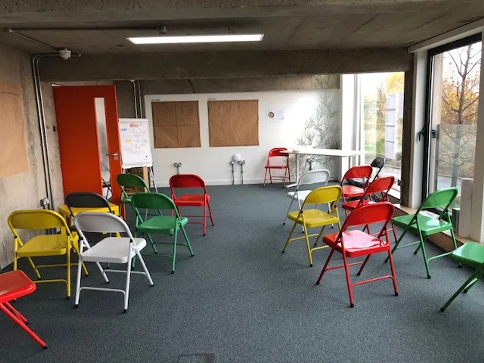 Meeting room with different coloured chairs