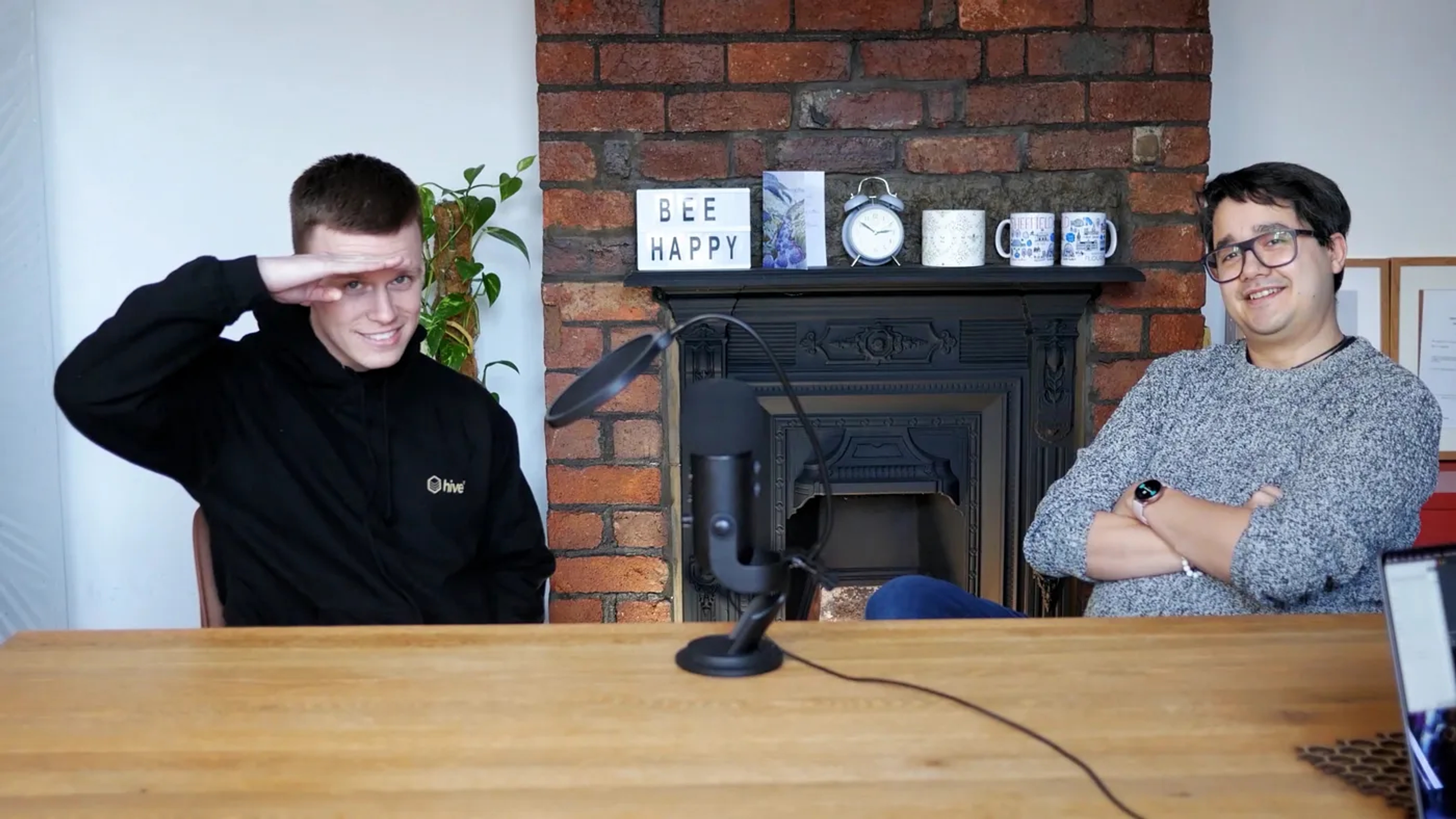 A picture of Tom and Allan sat at a podcast table smiling