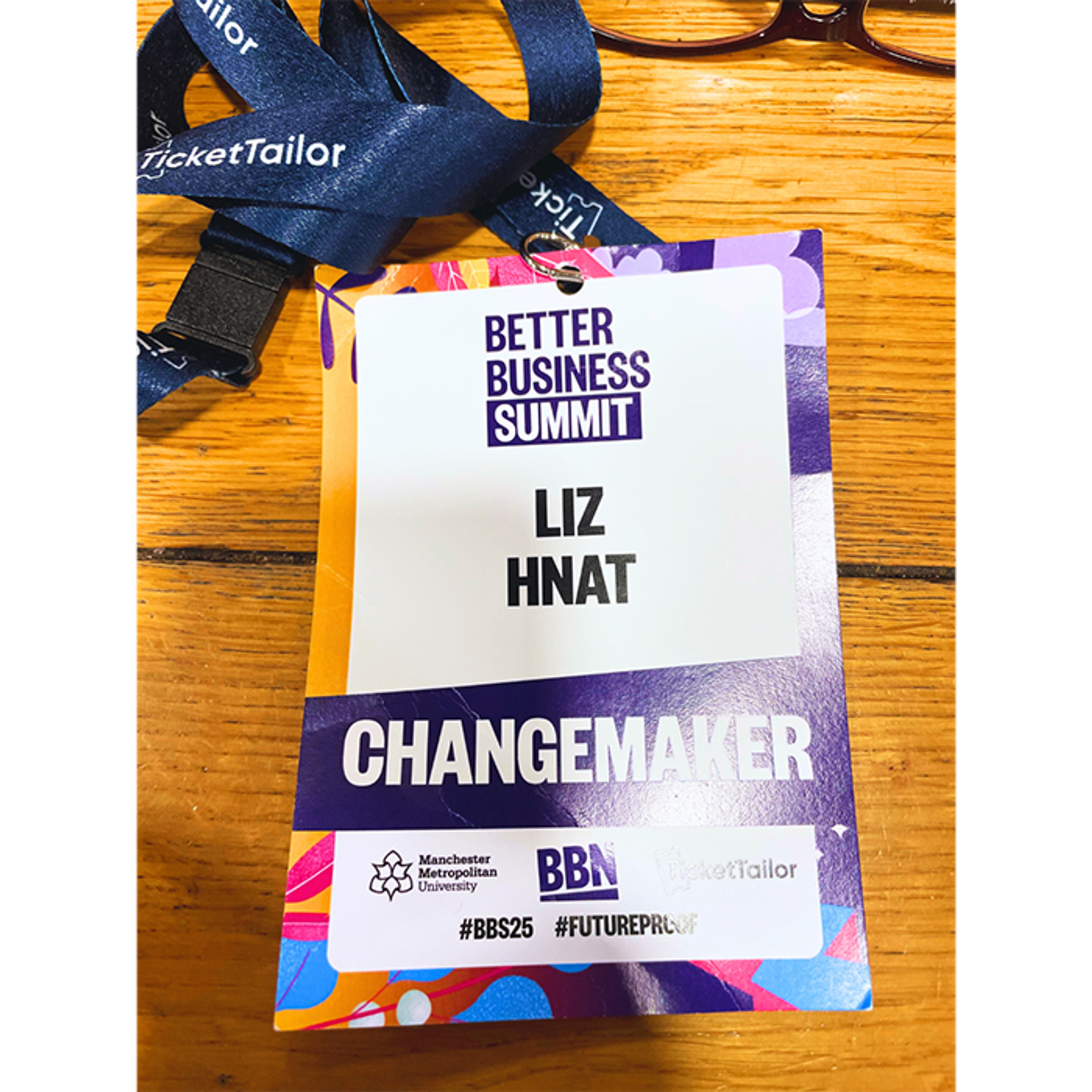 A picture of a lanyard which says, 'Better Business Summit, Liz Hnat, Changemaker'.