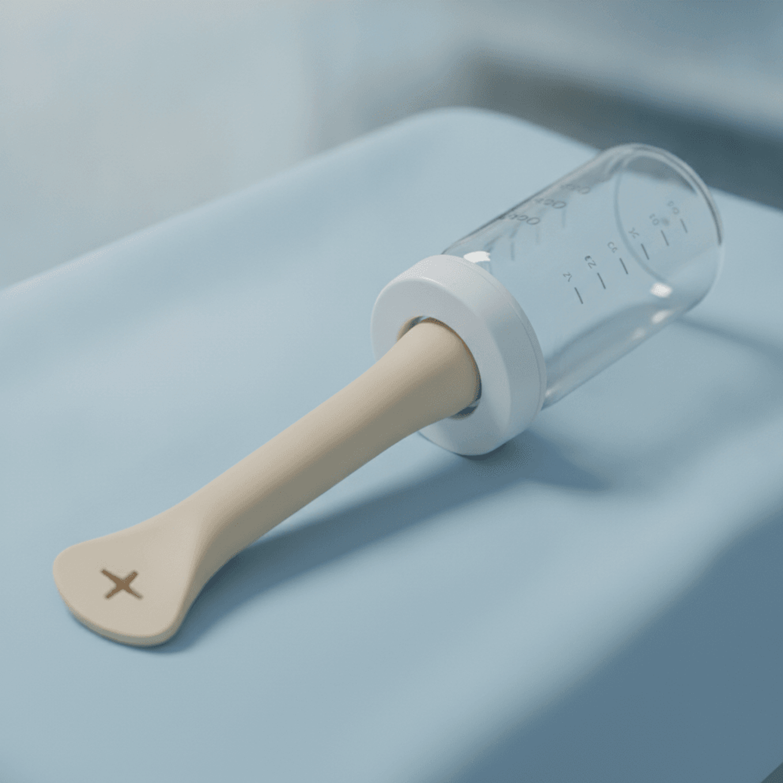 Specialized cleft-palate feeder bottle with soft elongated nipple on white linen.