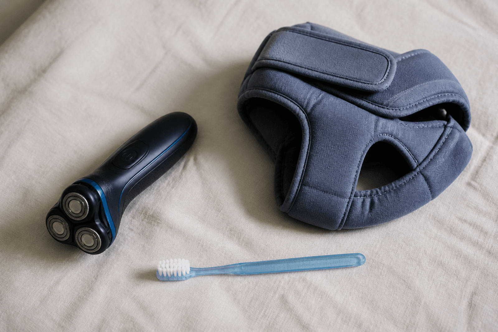 Soft toothbrush and soft protective gear on clean linen for bleeding precautions.