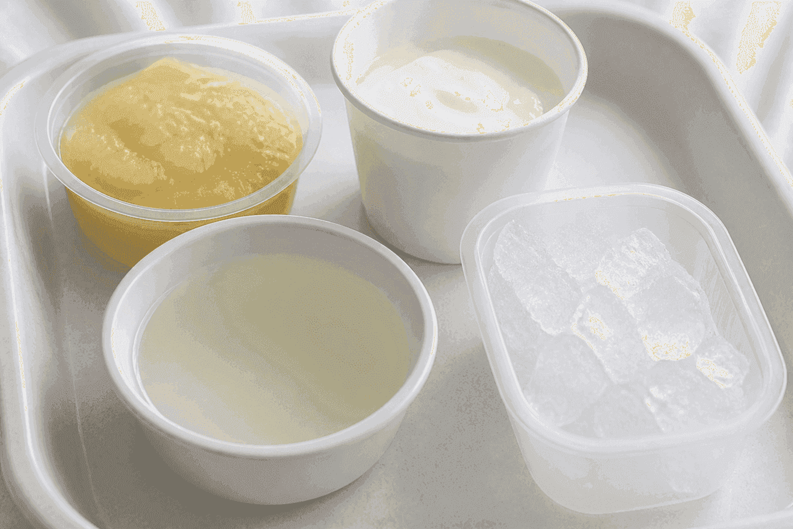 Soft-food tray with applesauce, yogurt, cool liquid, and ice chips.