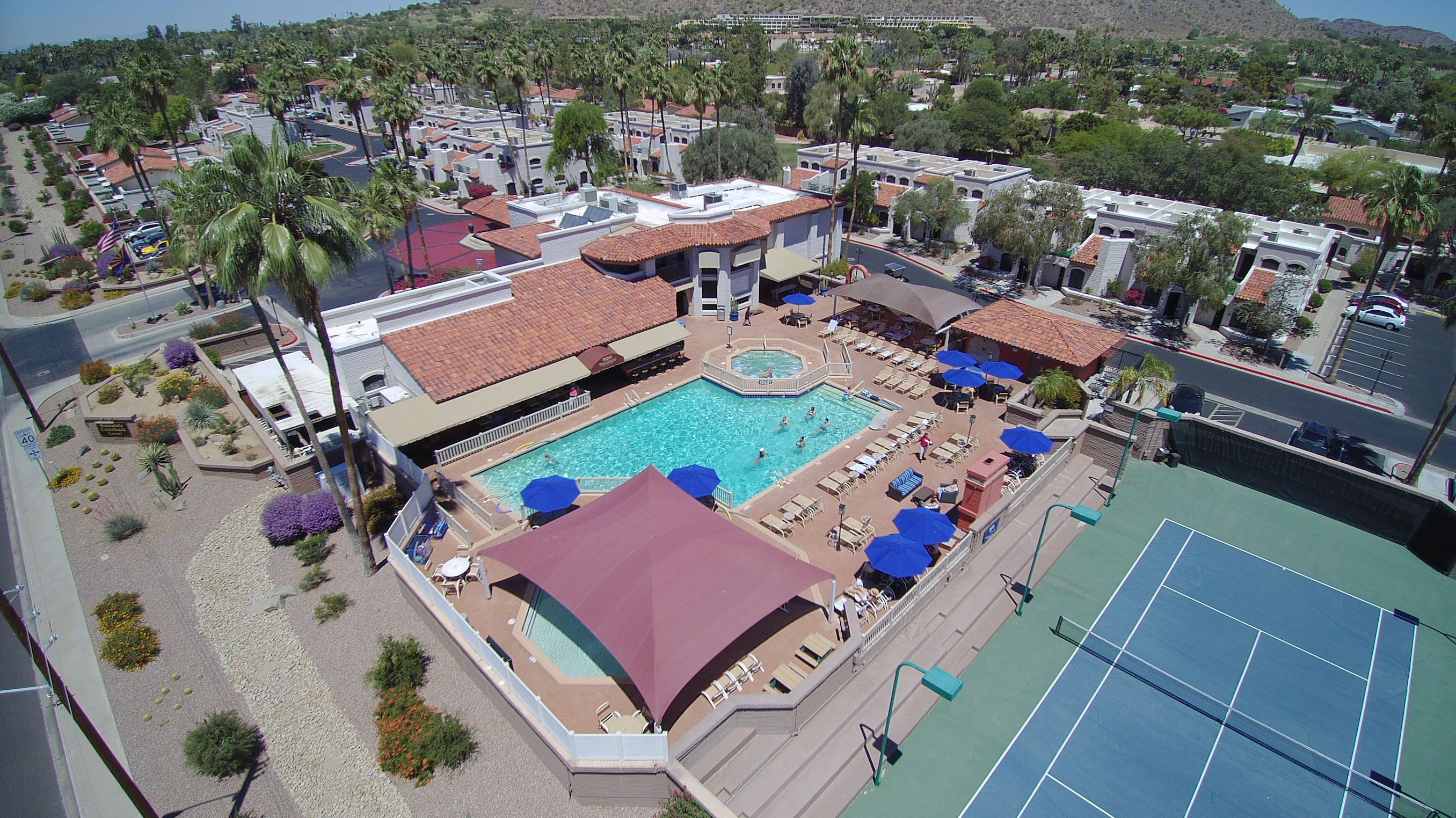 An aerial view of Scottsdale Camelback Resort, including swimming pool, tennis court, and accommodations. 