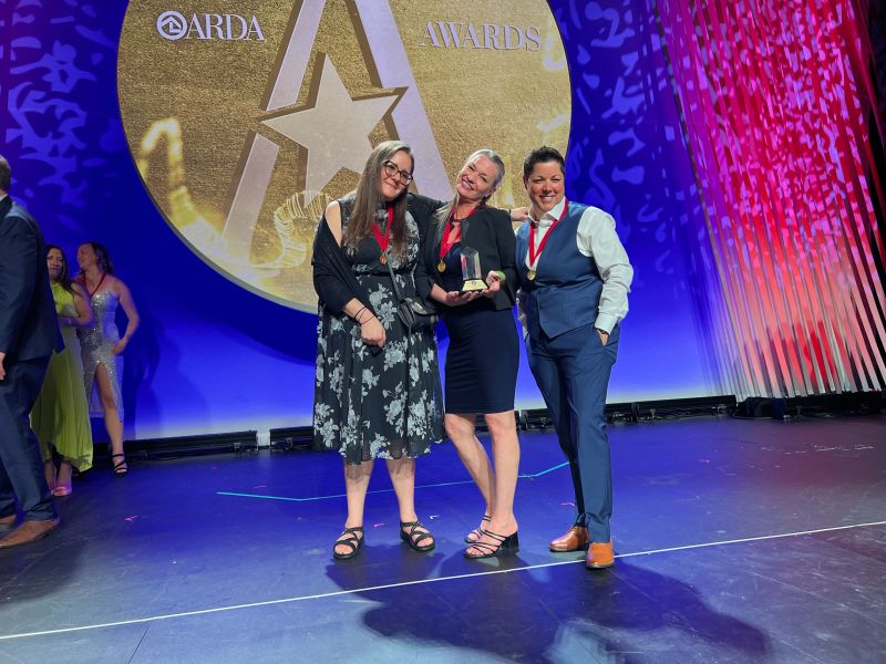 Rebekah Sandifer, Mandy Carrillo, and Julie Witt, Vacatia's award winners, onstage at the American Resort Development Association's annual conference, in Las Vegas.