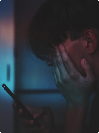 Bilde av ung gutt som holder telefon