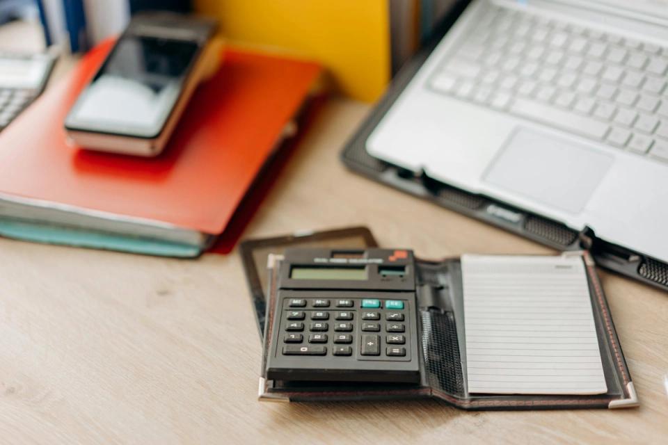 Organized accounting workspace with calculator and ledger