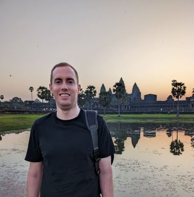 Lucas Silbernagel standing in front of Angkor Wat at sunrise