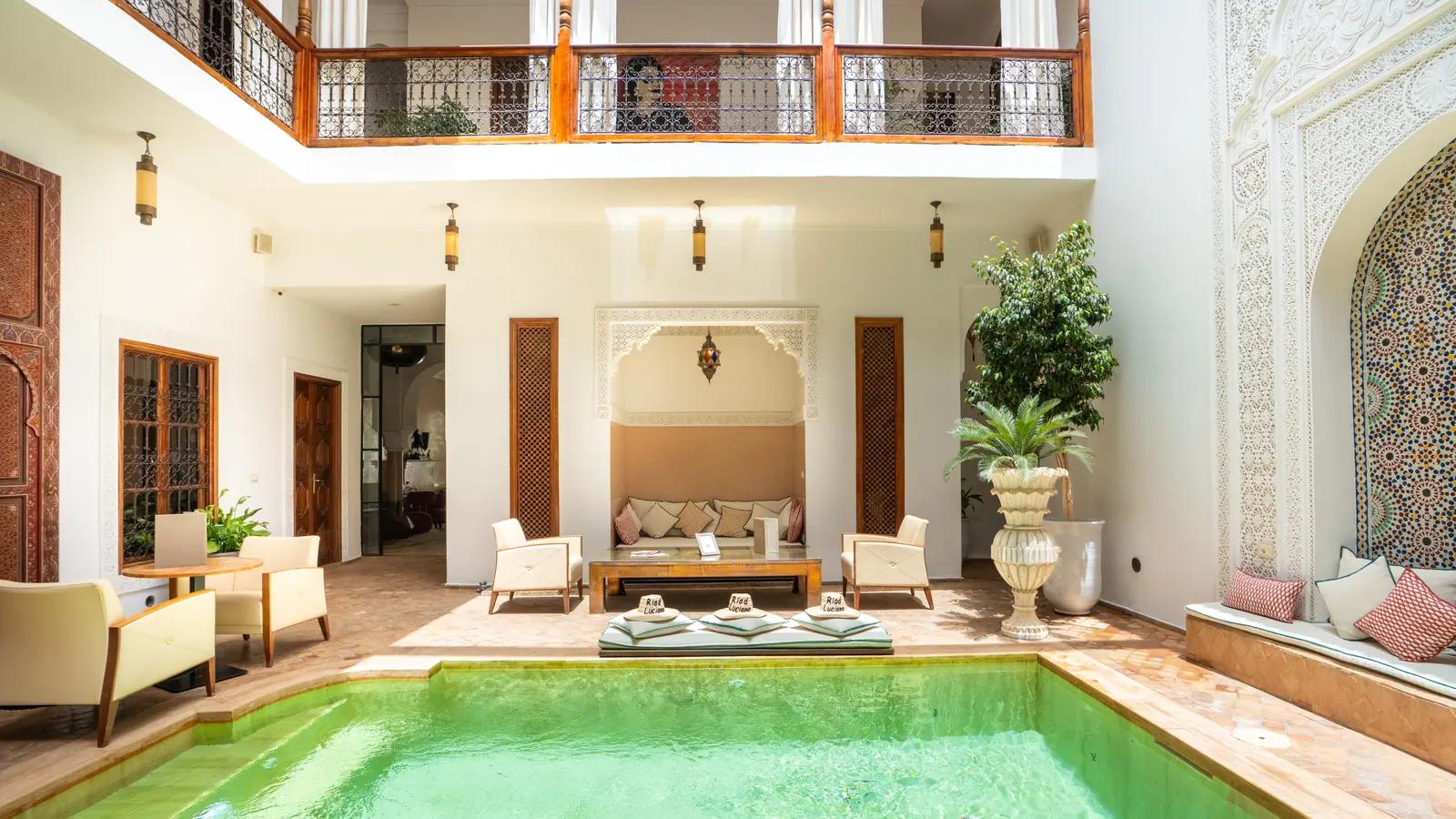 Courtyard pool framed by carved plaster