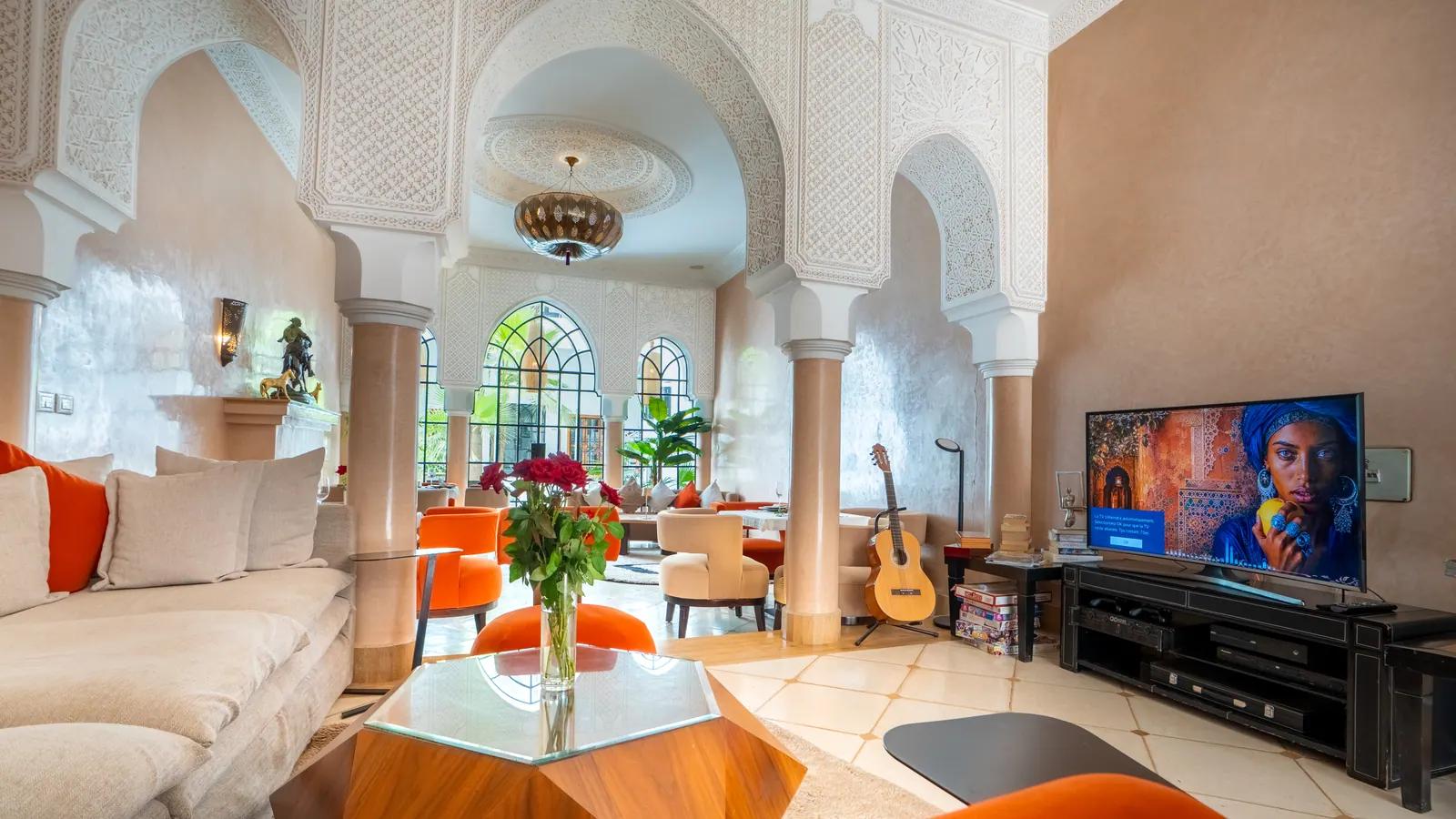Lounge with Moroccan arches and orange armchairs