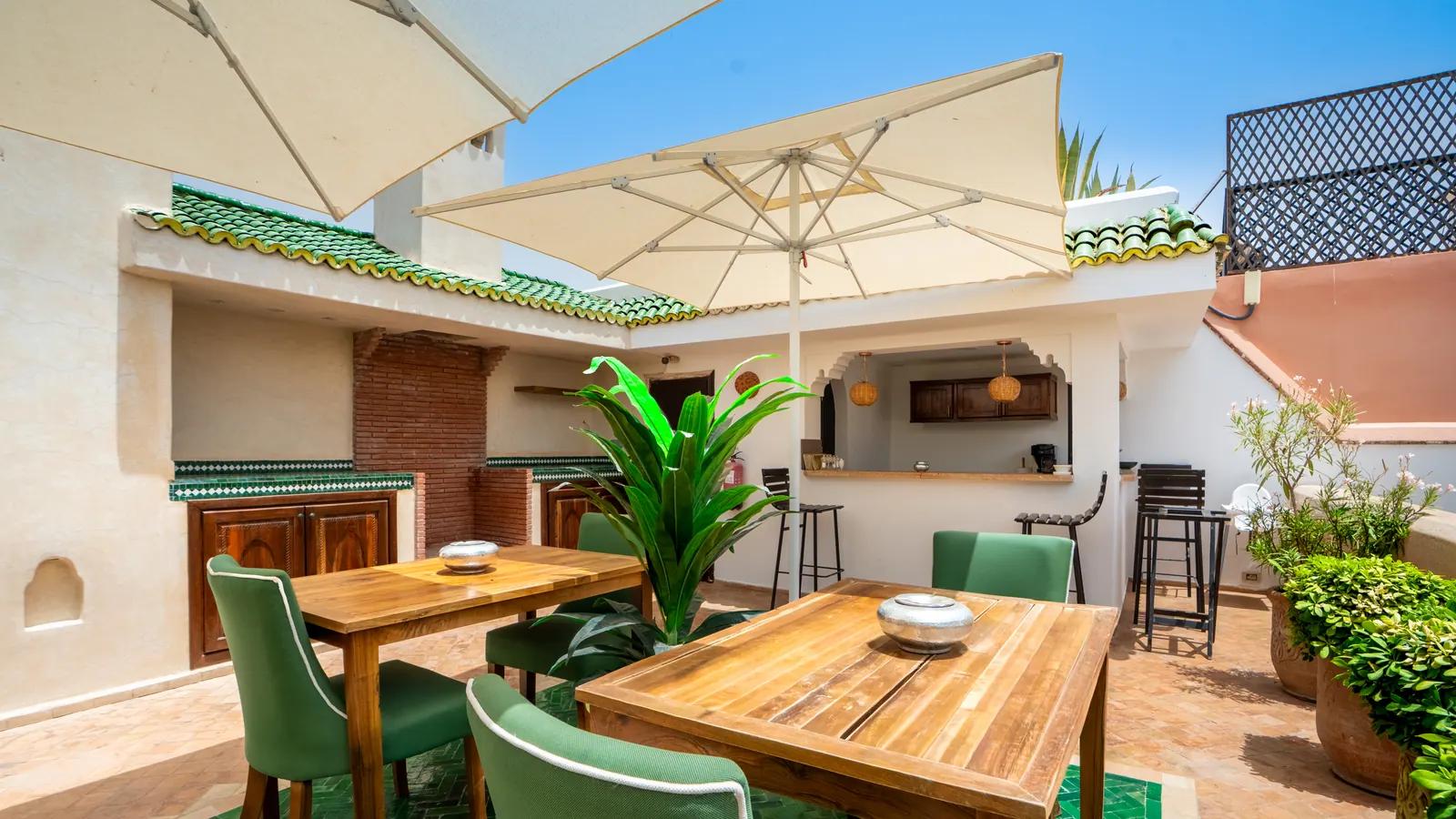 Dining tables beneath rooftop parasols